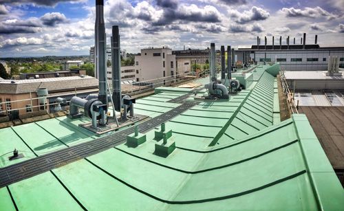 The newly refurbished roof of the Joseph Black Building with Sarnafil Membrane S327-15EL in patina green