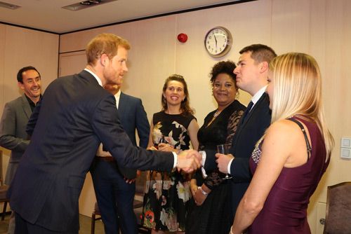 Prince Harry congratulates the Hilti team for their Volunteer Company of the Year Award at the WellChild Awards.
