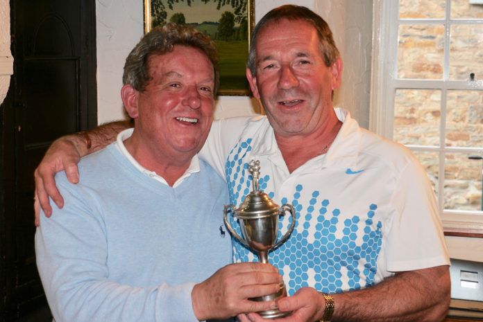 Martin-Brooks’ managing director, John Elmore (left), celebrates his hole-in-one at the firm’s charity golf day with winner, Paul Joynes (right)