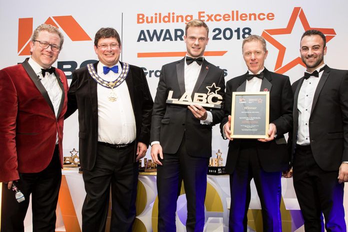 Actis specification manager, Dan Anson-Hart, joins Jon Culshaw to present a trophy to the winner of the best individual new build house at the LABC Building Excellence Awards