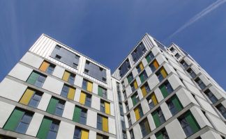 Dramatic angle of a highrise building with a blue sky background