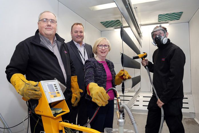 Left to right: Karl Prosser, managing director, Mark Wheddon, head of delivery at the University of Derby, Maggie Throup and Darren Barker, a welder/fabricator at Dales Fabrications, at the penultimate part of the process where the coating is applied