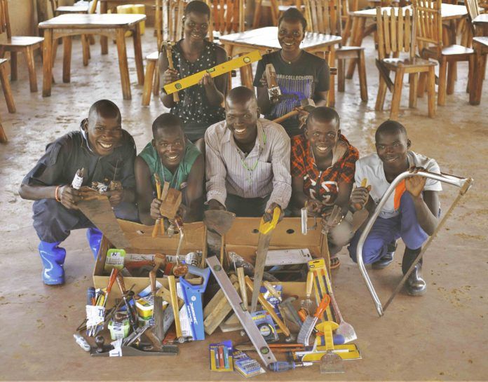 Some of the young people in Uganda who are supported by Amigos with tools that have previously been donated by RGB customers