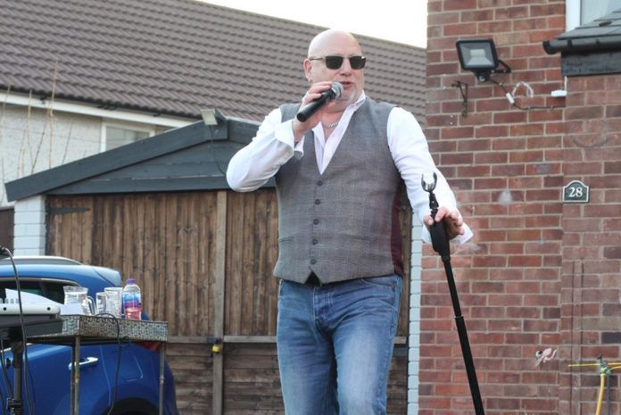 SIG's Andy Morse singing and raising money for charity