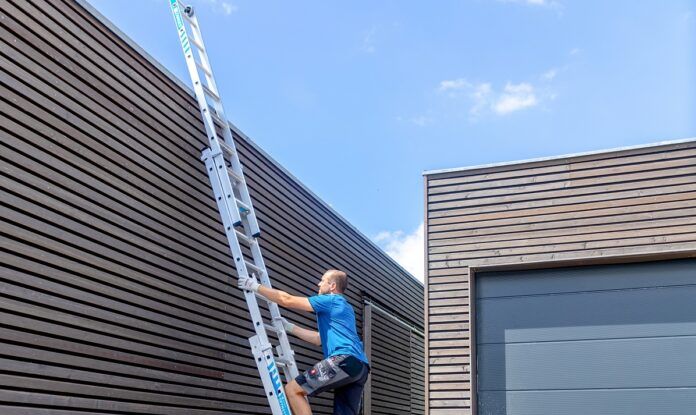 Man climbing up ladder in the sun