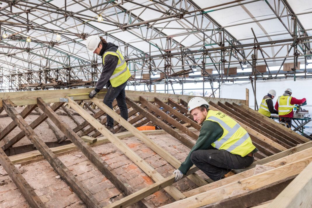 Prince’s Foundation placements working on the roof at Shrewsbury Flaxmill Maltings © Historic England Archive.